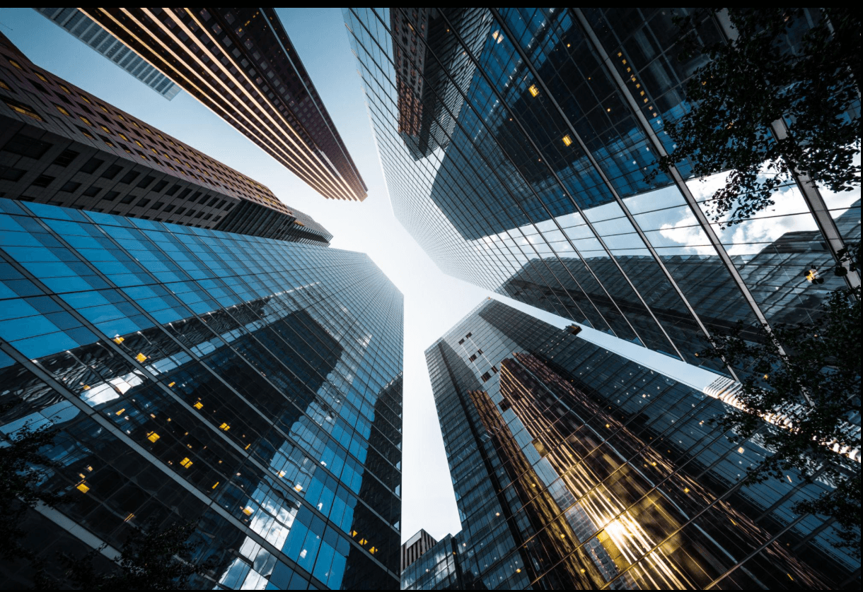 Looking up at glass office towers in a financial district